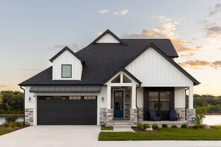 White home with a new black shingle roof by Cairns Roofing